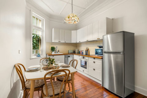 Natural light fills the kitchen and dining area, creating an inviting setting for relaxed meals