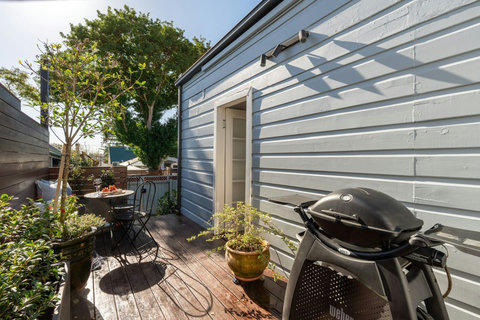Sunny rear deck with BBQ and outdoor seating