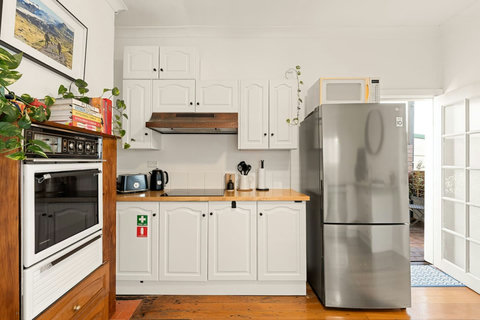 Light-filled kitchen with timber floors and everyday appliances