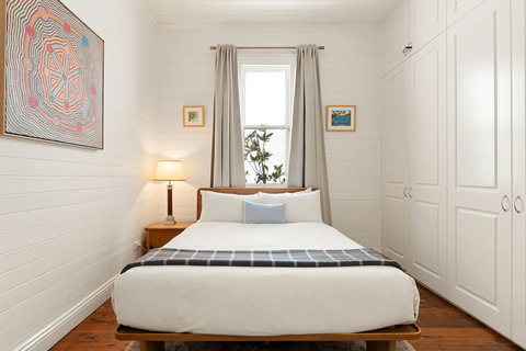 Queen bedroom with soft lighting and homely touches