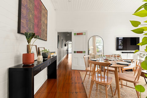 Dining area with warm timber floors and period charm