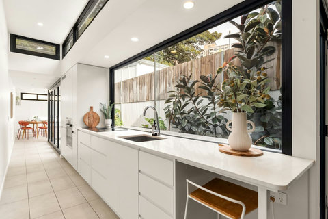 Prepare meals in the streamlined kitchen while enjoying an outlook over the courtyard garden.