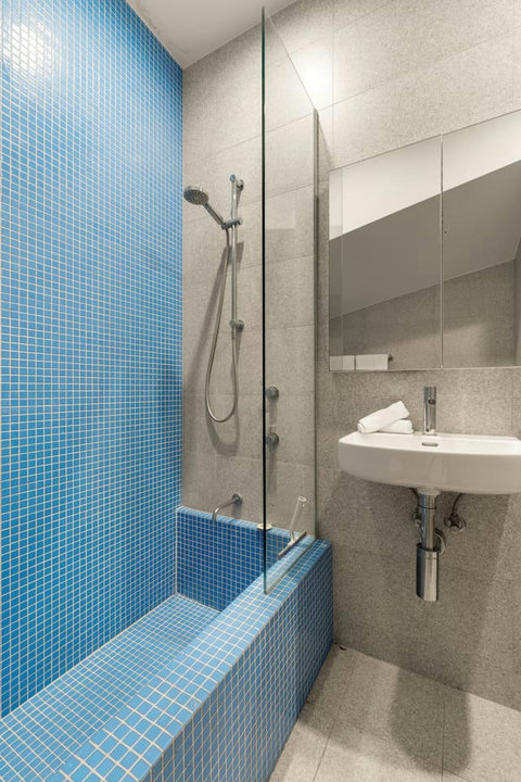 Refresh in the contemporary bathroom, featuring bold blue mosaic tiles and modern fittings.