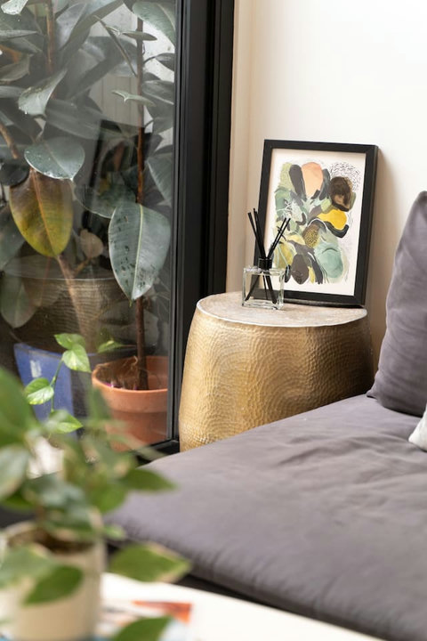 Thoughtful artwork and a sculptural side table bring a polished finishing touch beside the lounge.