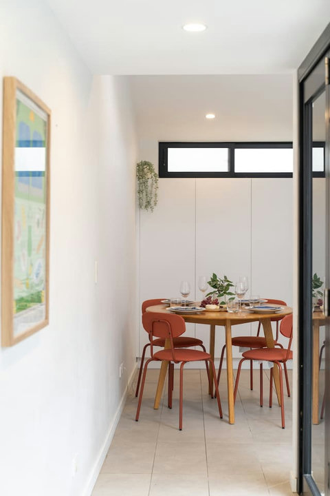 Gather around the dining table for relaxed meals in a bright setting overlooking the courtyard.