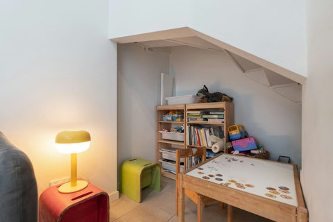 Browse a book or board game from the built-in shelves during a relaxed evening at home.