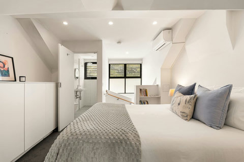 The spacious upper bedroom features air conditioning, built-in storage and easy access to the bathroom.