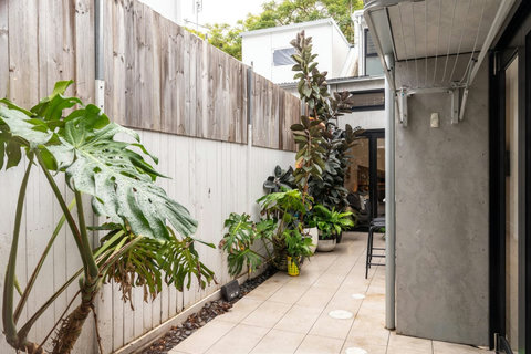 Follow the leafy courtyard passage between the home’s indoor and outdoor spaces.