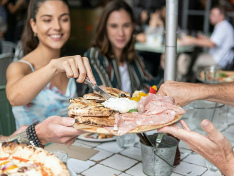 Share generous plates and good conversation at one of the neighbourhood’s vibrant dining spots.