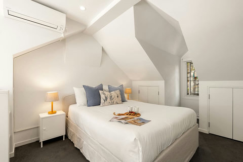 Sloped ceilings and soft bedside lighting create a cosy and calming upstairs retreat.