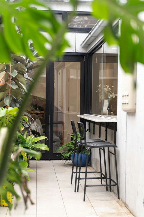 Courtyard Bar | Pull up a stool for morning coffee or casual drinks surrounded by lush greenery.