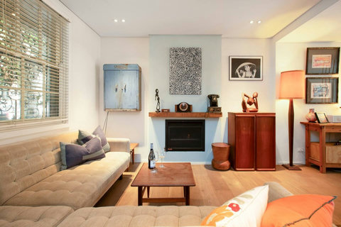 A relaxed lounge setting filled with natural light, distinctive artwork and thoughtful vintage-inspired details