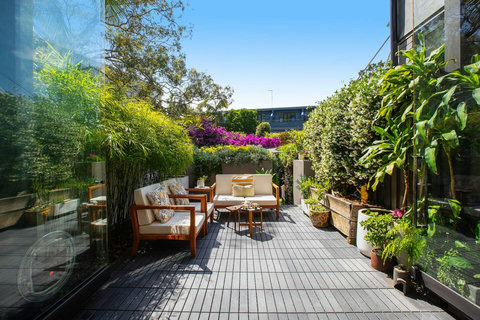 Leafy private courtyard with outdoor seating, creating a peaceful retreat in the heart of Surry Hills