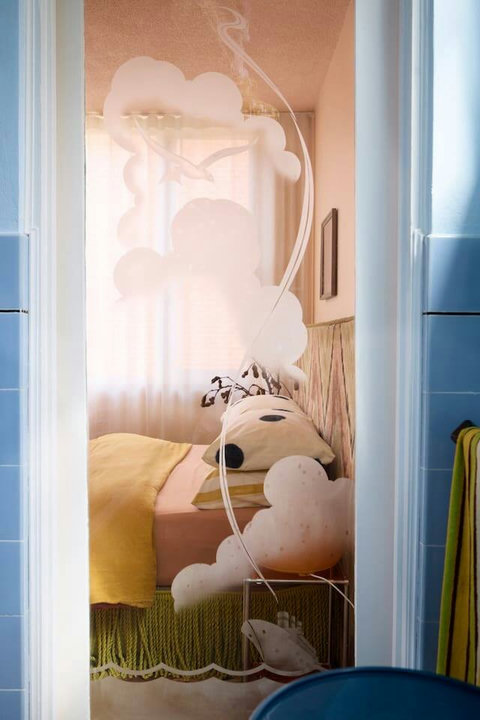 Thoughtful design carries through every room, with a glimpse from the bathroom into the colourful bedroom retreat