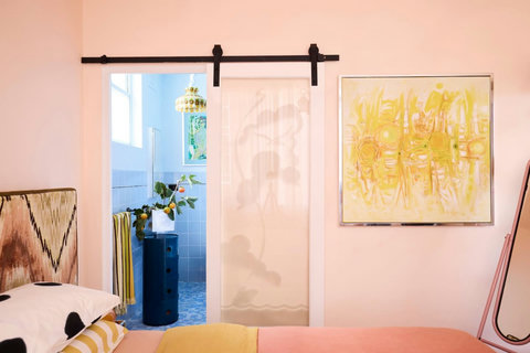 A bedroom that feels anything but ordinary, with curated artwork, layered colour and a beautifully individual style