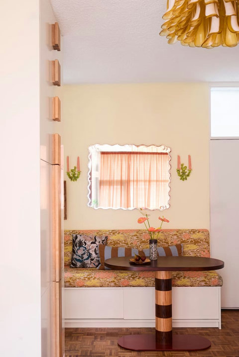 The dining nook is full of personality, with vintage-inspired upholstery, playful details and a cosy spot for two