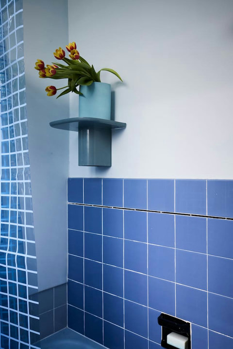 Retro blue tiles and thoughtful styling bring a fresh dose of personality to the bathroom