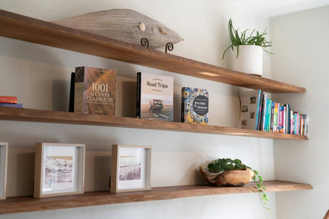 Timber shelving with books, artwork and decorative touches adding character to the living space