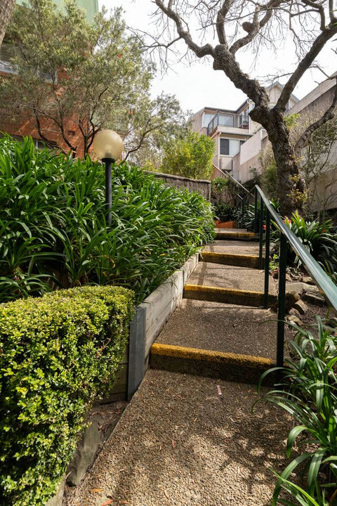 Garden steps surrounded by established greenery, forming part of the property's outdoor approach