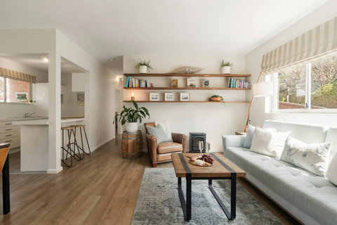 Bright, welcoming open-plan space with comfortable seating, natural light and a relaxed coastal feel