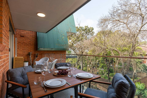 Balcony | Enjoy alfresco dining surrounded by leafy Manly views, perfect for a relaxed meal or evening drink