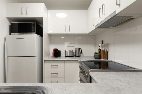 Keep snacks and drinks close at hand with a full-size fridge and convenient kitchen appliances