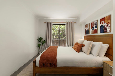 Wake up to leafy outlooks from the peaceful queen bedroom