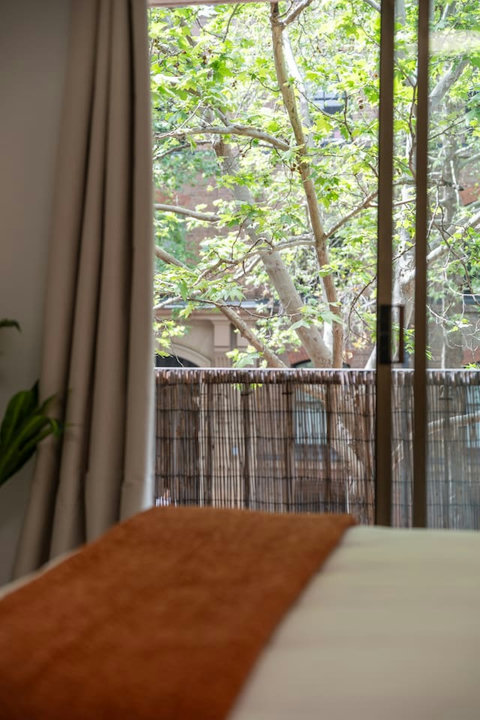 Wake to calming greenery from the bedroom, a peaceful start before a day in the city