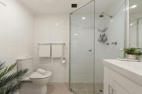 Freshen up in the bright modern bathroom with a spacious glass-enclosed shower