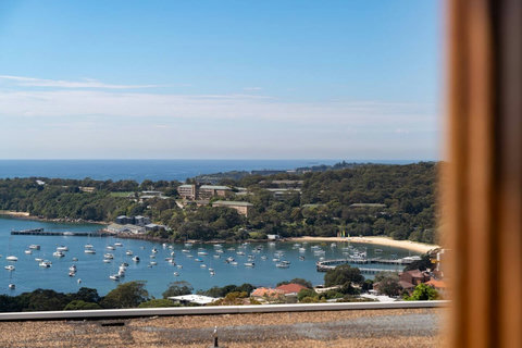 Elevated outlook across Balmoral Bay, with boats on the water and the harbour foreshore beyond