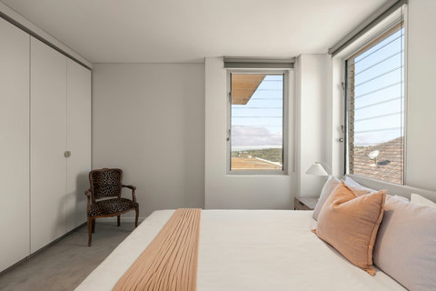 Bedroom 3 | A welcoming bedroom featuring a queen bed and built-in storage, ideal for family or additional guests.
