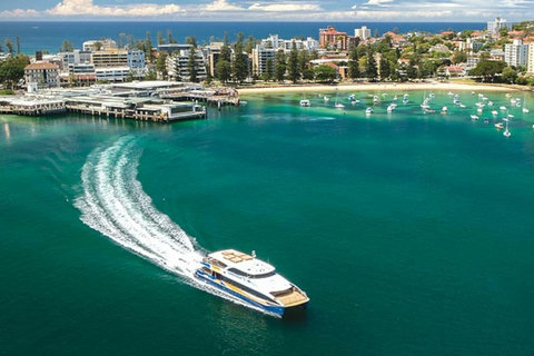 A classic Sydney Harbour scene with ferries, boats and the Manly waterfront in the distance