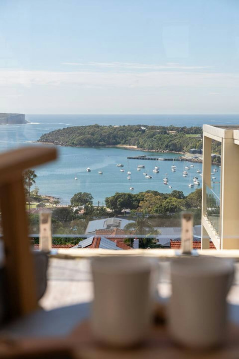 Sweeping views over Balmoral Bay, with boats below and the foreshore framed by greenery