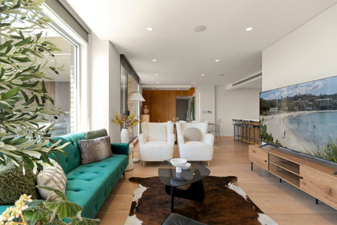 Spacious lounge with large windows, comfortable seating and the harbour outlook forming part of the room