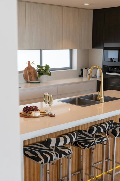 Large island bench with double sink and generous preparation space, ideal for easy meals at home