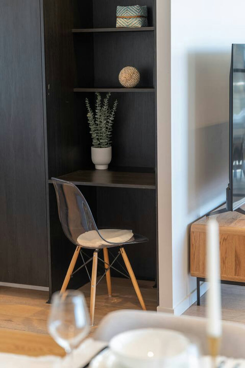 Compact built-in desk nook provides a practical spot for working or planning the day