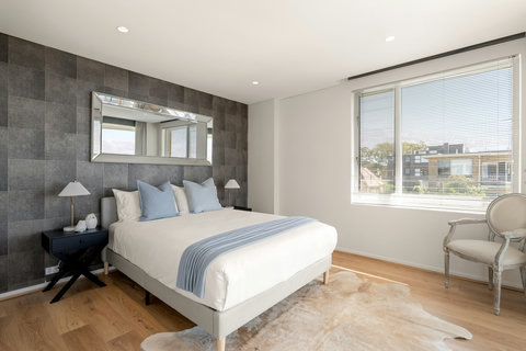 Main Bedroom | Unwind in a comfortable queen bed with built-in storage, a private ensuite and direct terrace access.