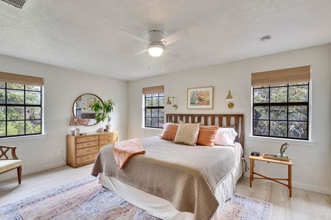 Spacious room, natural light, view of backyard, shades, TV, closest and dedicated workspace with desk.