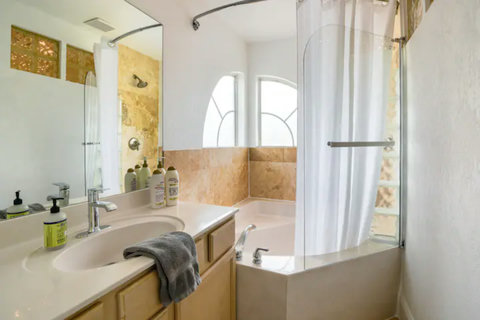 Relaxing Bathroom with Shower, Tub & Essentials - Unwind and refresh in our well-appointed bathroom.