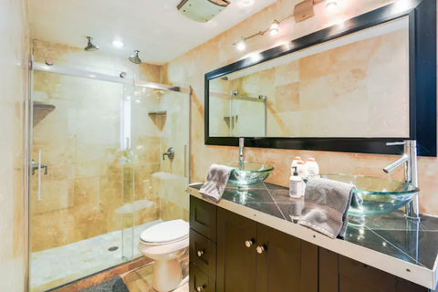 Modern Bathroom with Dual Sinks and Showers - Enjoy convenience and style in our well-equipped bathroom.