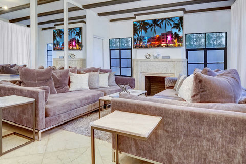 Living room with oversized custom-made designer sofas made in California with designer pillows and an 86-inch smart TV for the movie theater entertainment experience. Netflix and Amazon movies are included. 