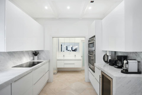 Entertaining Perfect Private Chef Dining Kitchen with Brazilian marble waterfall kitchen bar. Stainless build-in custom appliances with state of art induction cooking and wine fridge, soda stream, and nespresso cappucino maker.  