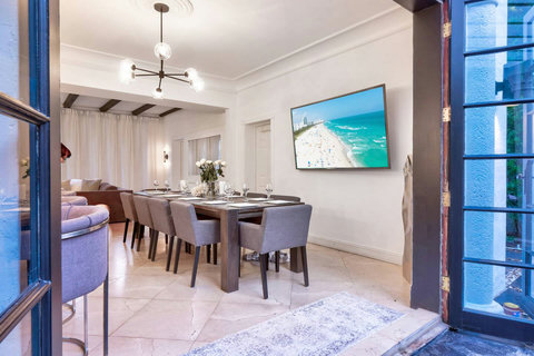 Entertaining open floorplan with Entertaining Dining room and Brazilian marble waterfall kitchen bar. Stainless build-in custom appliances with state of induction cooking and wine fridge, soda stream, Nespresso cappuccin maker, two 86-inch SmartTV