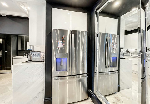 Entertaining Perfect Private Chef Dining Kitchen with Brazilian marble waterfall kitchen bar. Stainless build-in custom appliances with state of art induction cooking and wine fridge, soda stream, and nespresso cappucino maker.  