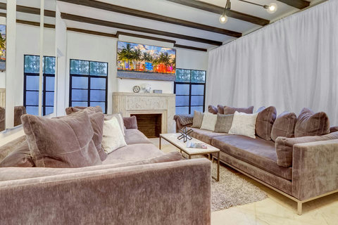 Entertaining open floor plan with oversized sofas and two 86 inch Smart TVs  
