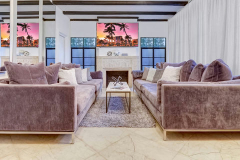 Entertaining open floor plan with oversized sofas and two 86 inch Smart TVs  