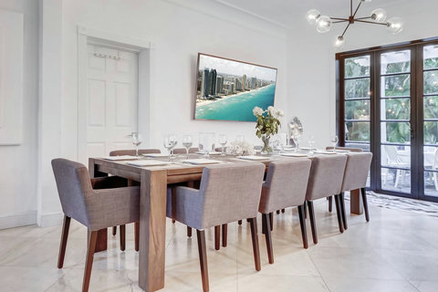 Entertaining open floorplan with Entertaining Dining room and Brazilian marble waterfall kitchen bar. Stainless build-in custom appliances with state of induction cooking and wine fridge, soda stream, Nespresso cappuccin maker, two 86-inch SmartTV