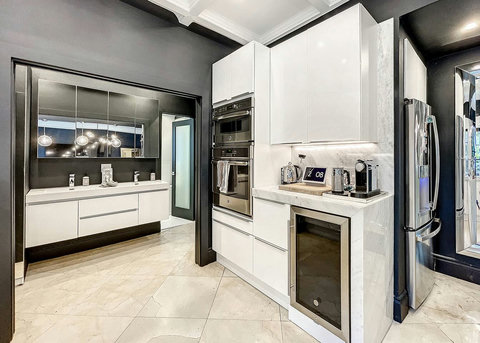 Entertaining Perfect Private Chef Dining Kitchen with Brazilian marble waterfall kitchen bar. Stainless build-in custom appliances with state of art induction cooking and wine fridge, soda stream, and nespresso cappucino maker.  