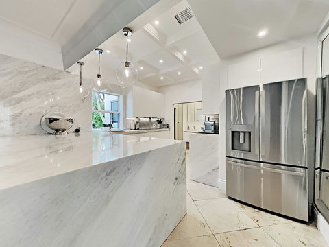 Entertaining Perfect Private Chef Dining Kitchen with Brazilian marble waterfall kitchen bar. Stainless build-in custom appliances with state of art induction cooking and wine fridge, soda stream, and nespresso cappucino maker.  