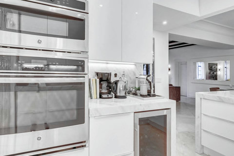 Entertaining Perfect Private Chef Dining Kitchen with Brazilian marble waterfall kitchen bar. Stainless build-in custom appliances with state of art induction cooking and wine fridge, soda stream, and nespresso cappucino maker.  